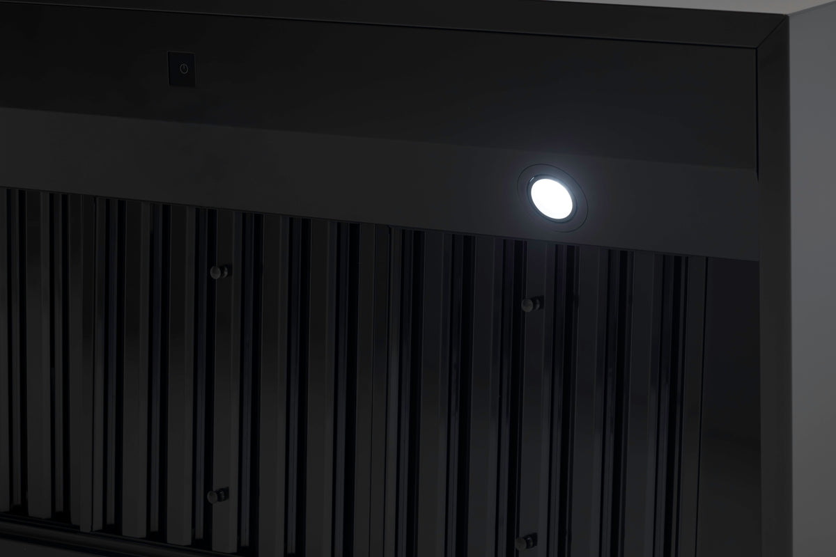 Stainless baffle filters inside a hood canopy, where the carbon cartridges mount behind
